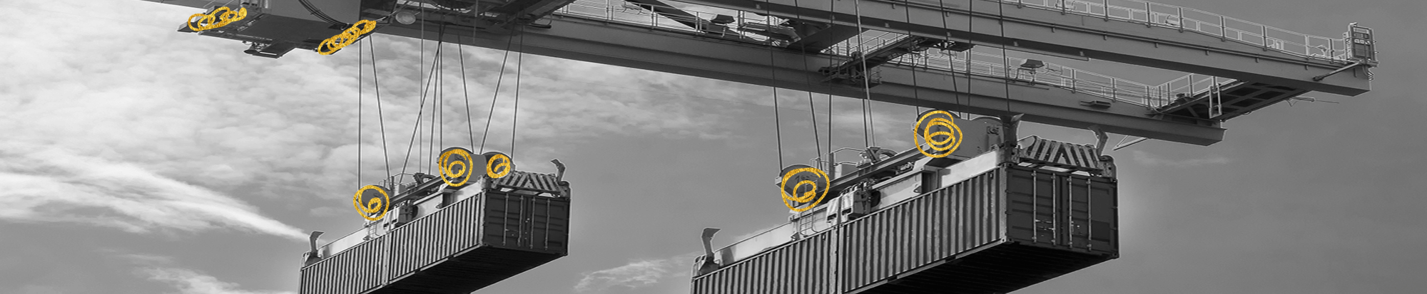 Industrial container crane featuring an integrated coupling and brake system for precise motion control